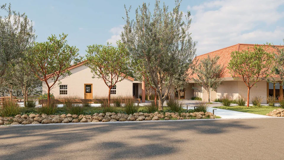 Street-level rendering of University AME Zion Church in Palo Alto, showing two cream stucco buildings with red tile roofs behind new trees, grasses and a low stone border.